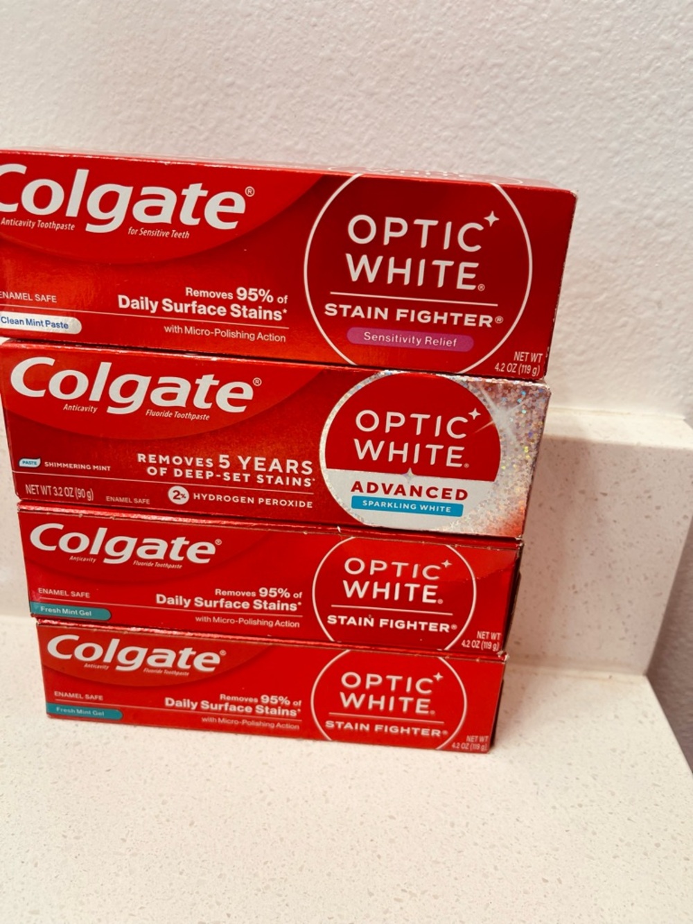 4 Colgate Optic White Toothpaste bundle assorted.